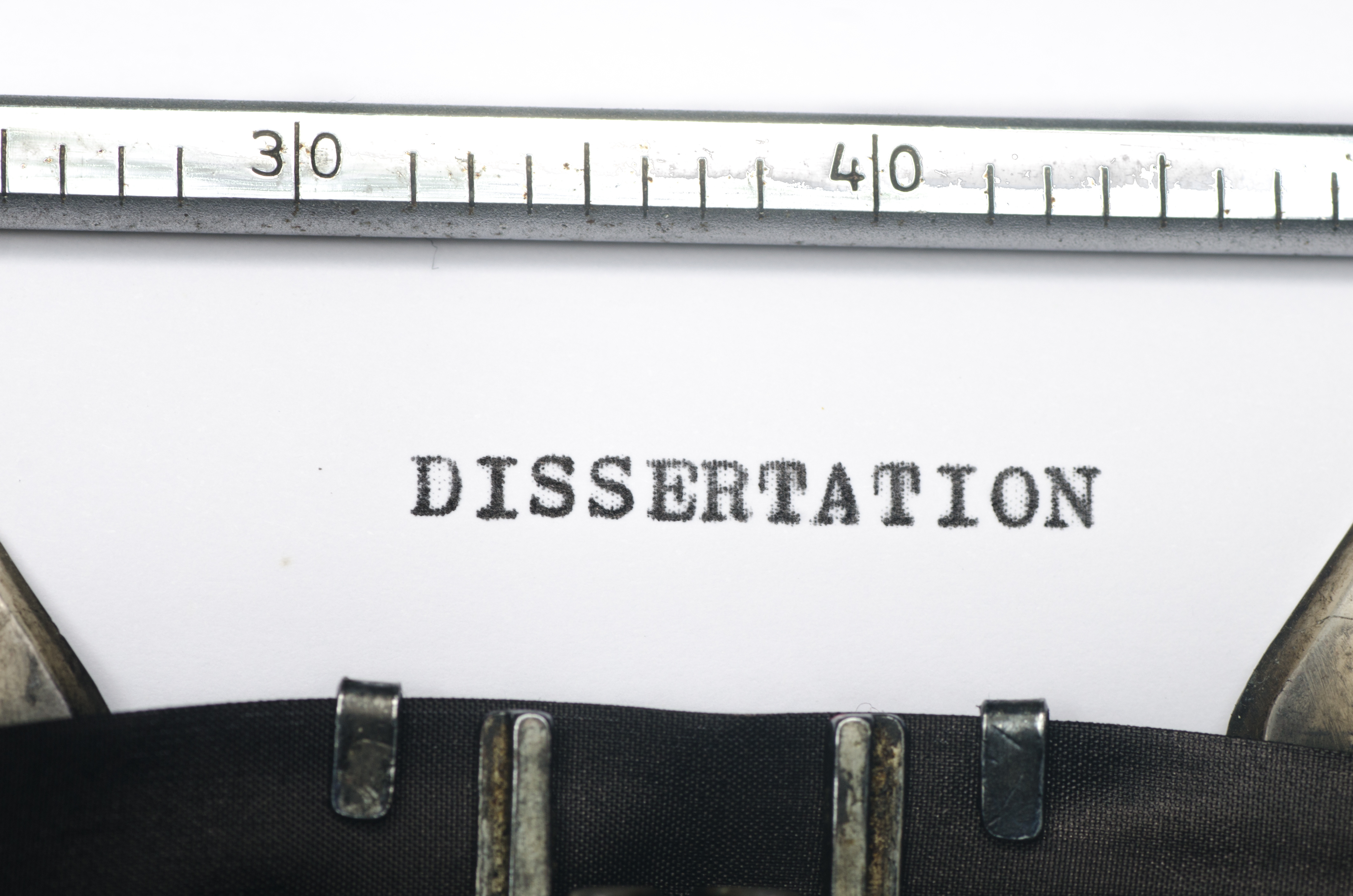 close-up shot of 'dissertation' written on a typewriter paper