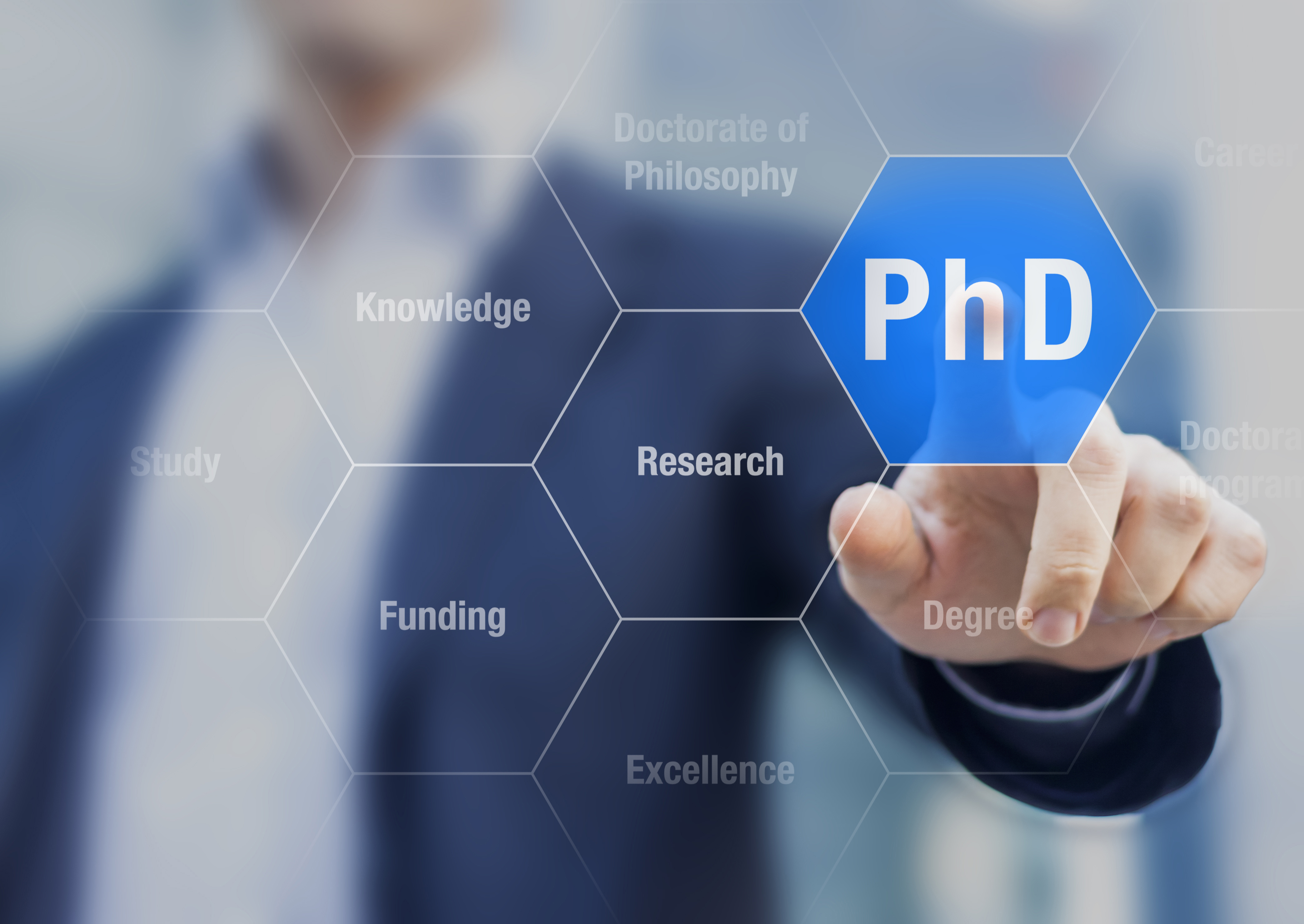 man in a blue suit touching a PhD graphic overlay