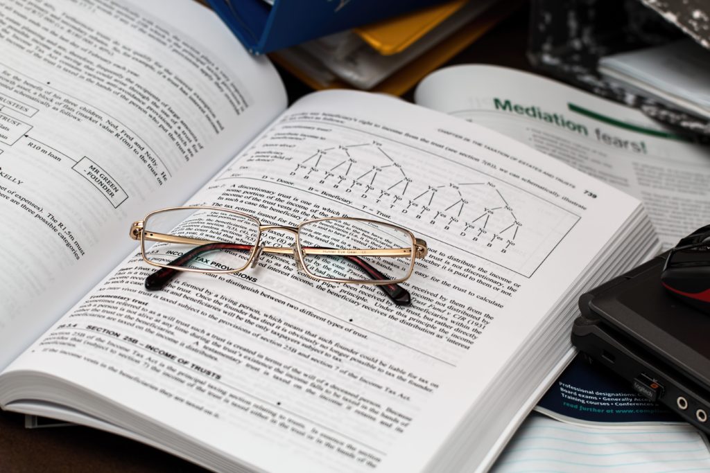 close-up shot of eyeglasses on an economics books