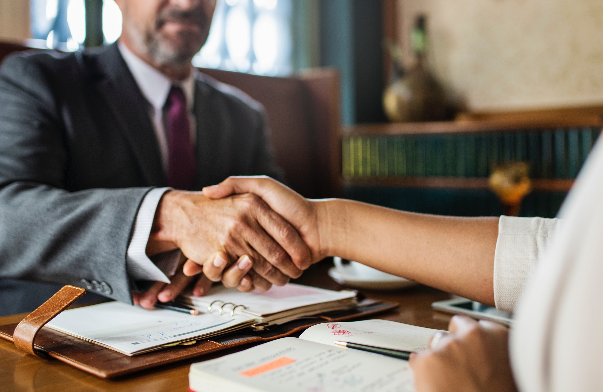 man and woman shaking hands in a professional office