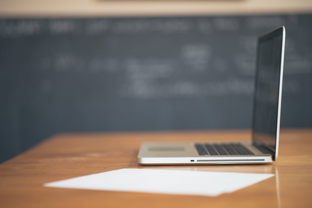 close-up shot of an open laptop in a college classroom