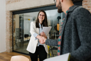 man and woman shaking heads before the start of a job interview