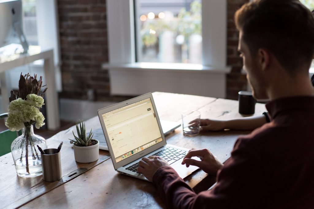 man browsing on his laptop