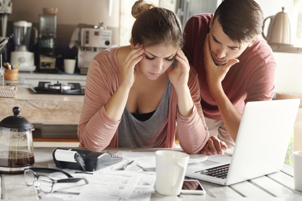 stressed out woman studying with her partner trying to help