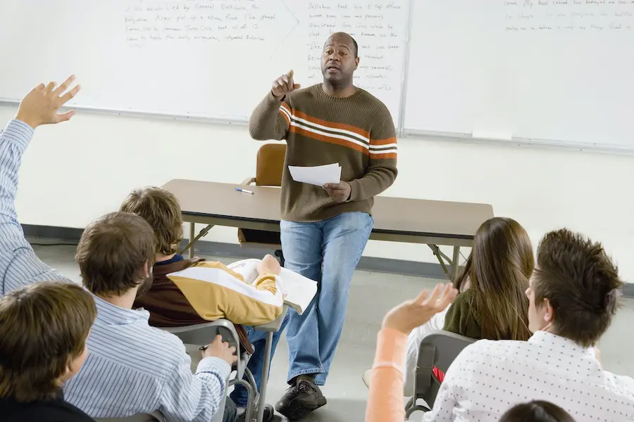 african american professor asking questions to his students