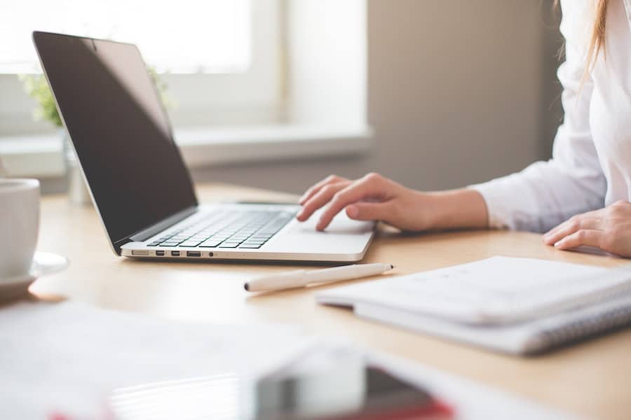 close up shot of a woman working on her laptop