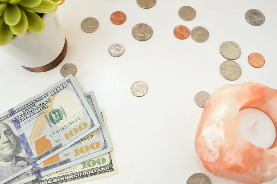 top view of coins and dollar bills on a white table