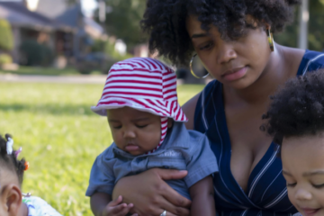 Dr. Brittne Martin holding her daughter outside