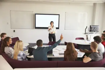 woman presenting a powerpoint in front of a group of people