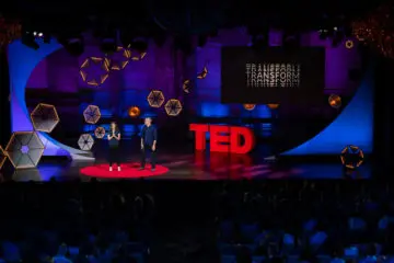 two people leading a ted talk on a stage