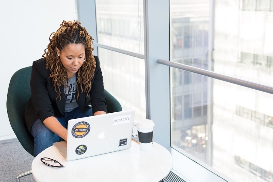 apa citation newspaper article no author african american woman working on her laptop next to the office window