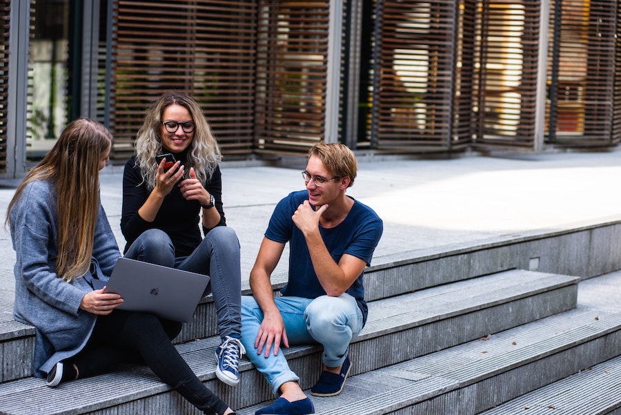 group of friends sitting on the stairs and chatting