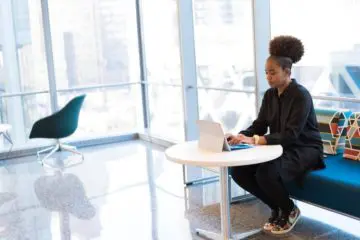 woman working on her laptop in a bright shared office