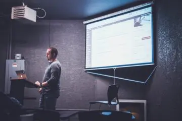 man presenting a power point presentation in class