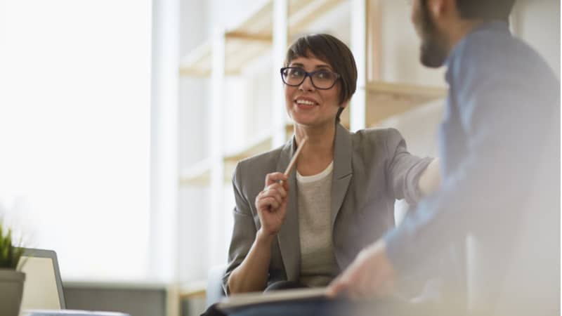 purpose of a research paper example middle aged woman with short hair explaining something to a colleague