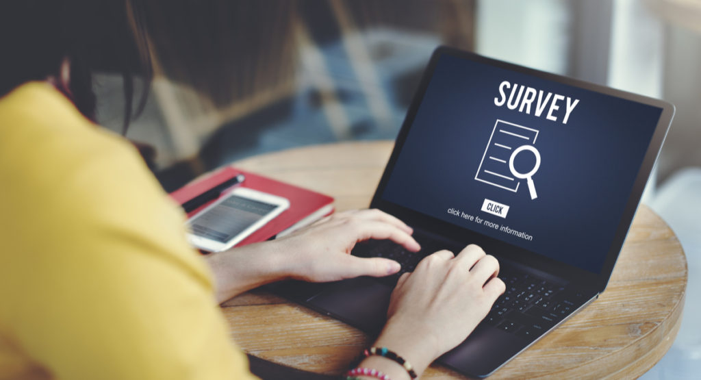 woman in yellow sweater starting a survey online