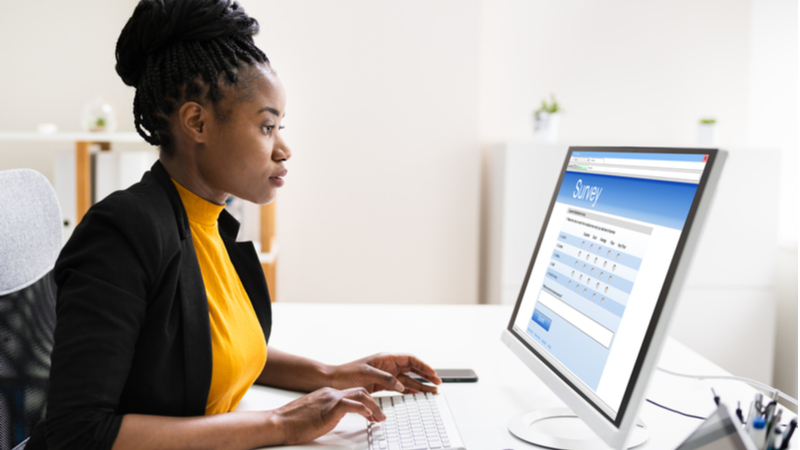 african american woman filling out a survey on the computer