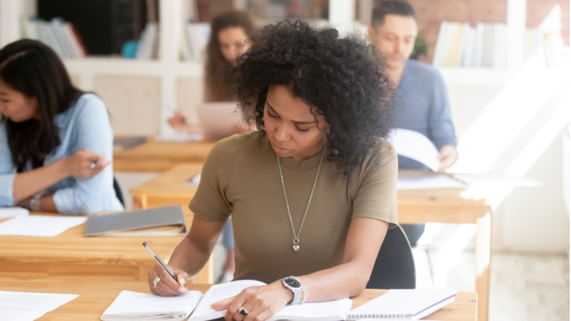 focused african american woman taking an exam