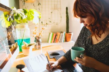 woman with red hair studying at home