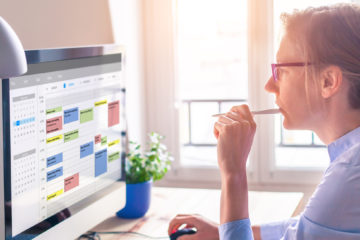 woman focused on planning her Dissertation Timeline on her computer