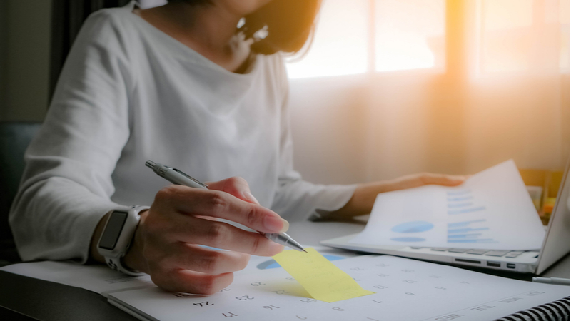 woman working on her budget and calendar