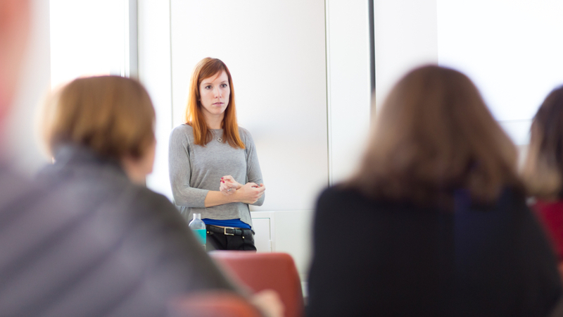 doctoral student with red hair defending her dissertation