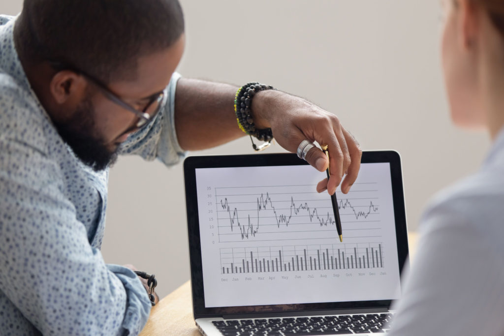 african american grad student helping his colleague interpret two-factor interactions