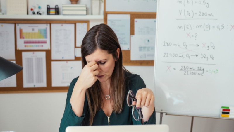 stressed out woman holding her head while taking a break