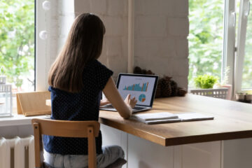 grad student analyzing data on her laptop