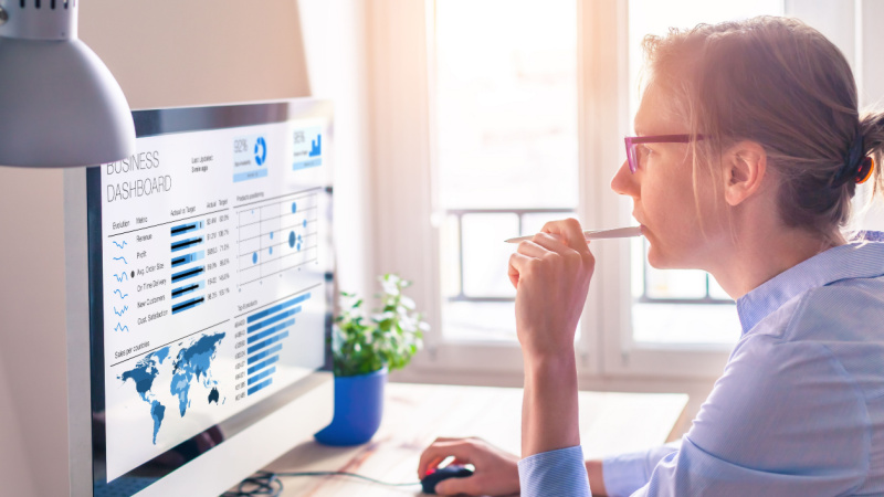 young woman focused an analyzing statistics on computer