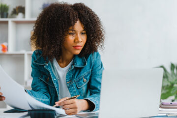 young african american student carefully comparing notes