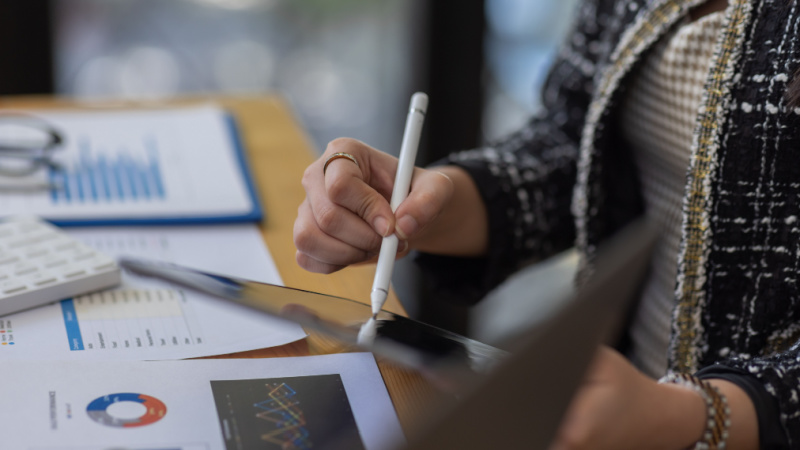 close up of woman using tablet to analyze stats