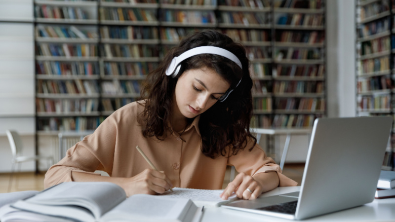 busy young woman studying in front of her laptop