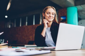 female phd student laughing at the laptop